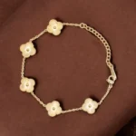 Clover Petal Grace – Golden Floral Charm Bracelet